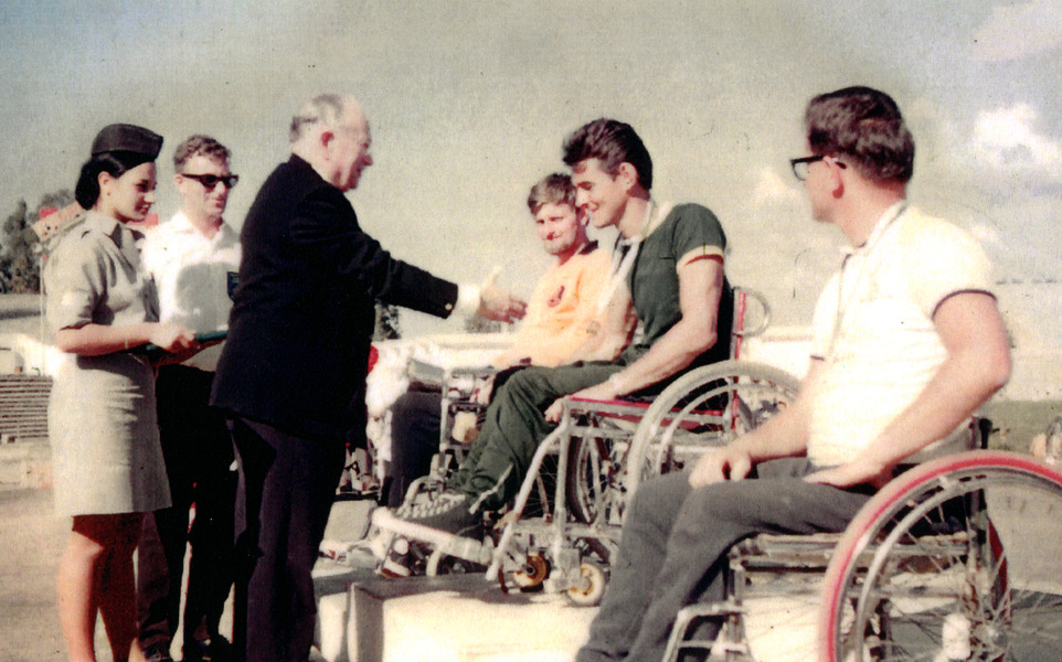 Neurosurgeon Ludwig Guttmann presents the gold medal to Paralympian Tony South