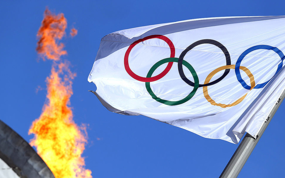 Symbols of the Olympic Games: the Olympic flame and the flag with the official emblem